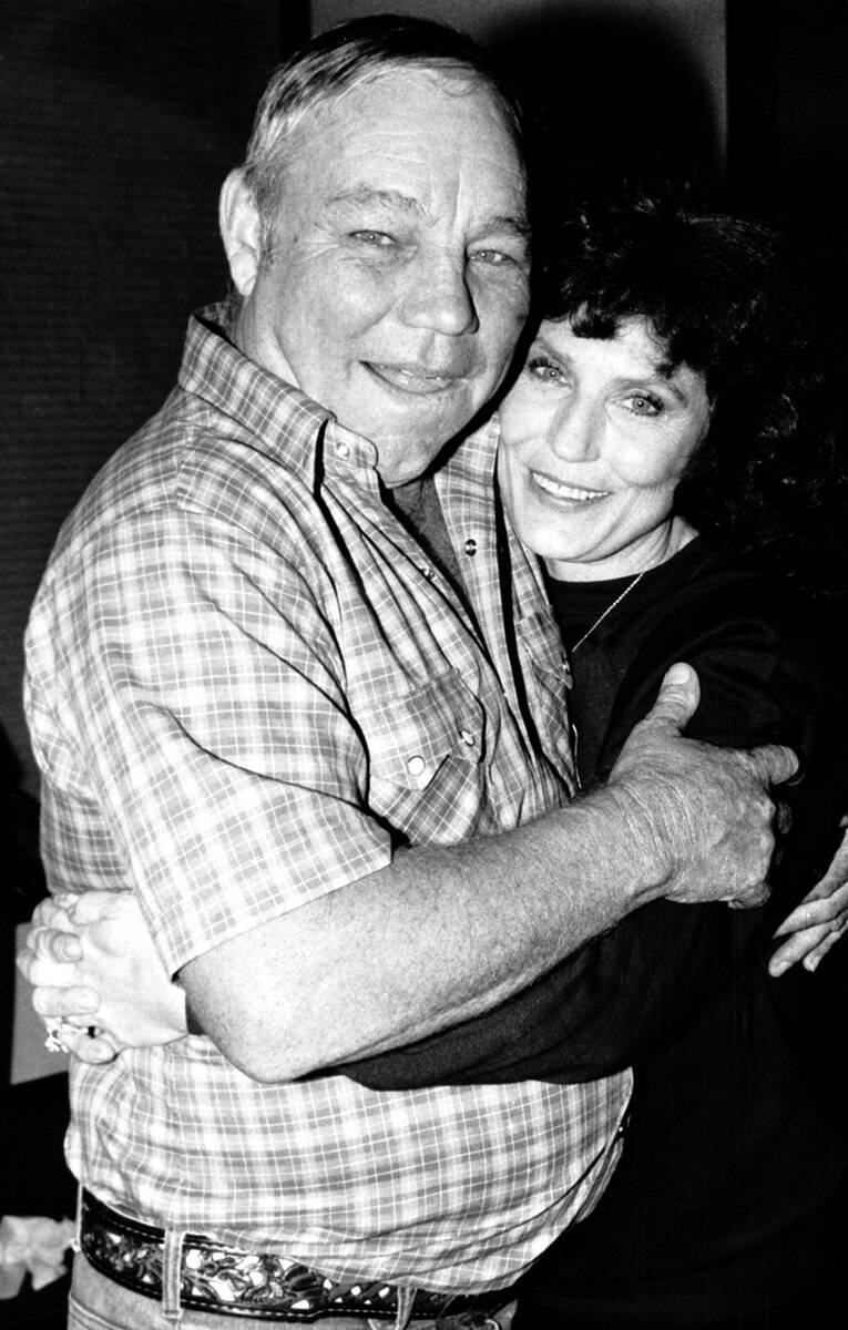 FILE - Country music singer Loretta Lynn embraces her husband, Oliver "Mooney" Lynn, ...