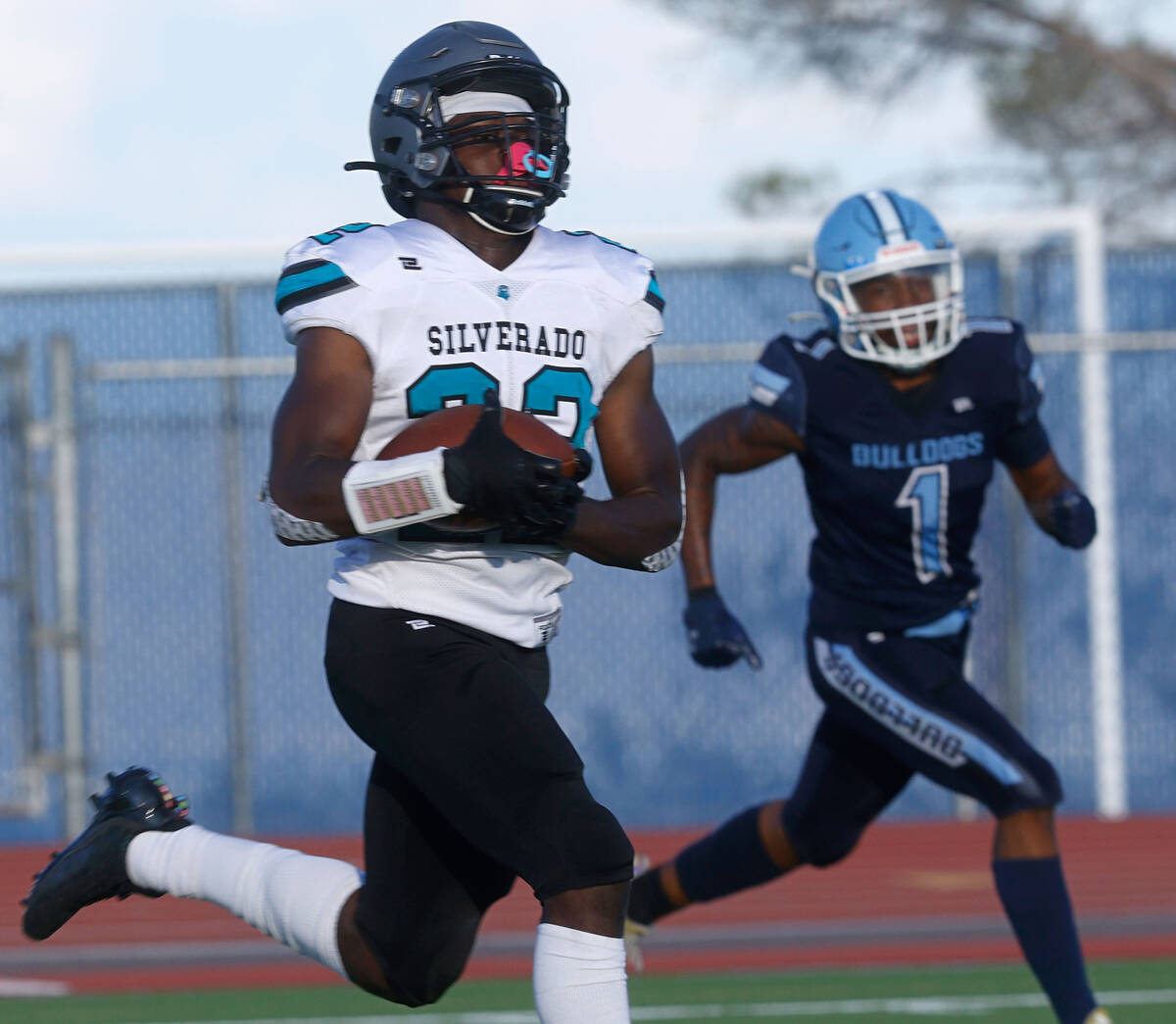 Silverado High School's Caden Harris , left, runs into the end zone for a touchdown as Centenni ...