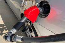 A car is shown at a gas pump, Friday, Jan. 21, 2022, at a gas station in North Miami, Fla. (AP ...