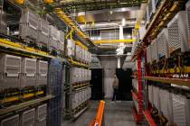 People explore the wireless network control room during a tour of Allegiant Stadium with lens a ...