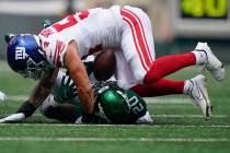 New York Giants linebacker Blake Martinez (54) tackles New York Jets running back Breece Hall ( ...