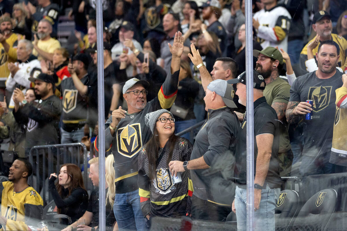 Golden Knights fans celebrate after defenseman Zack Hayes (65) scored a goal during the first p ...