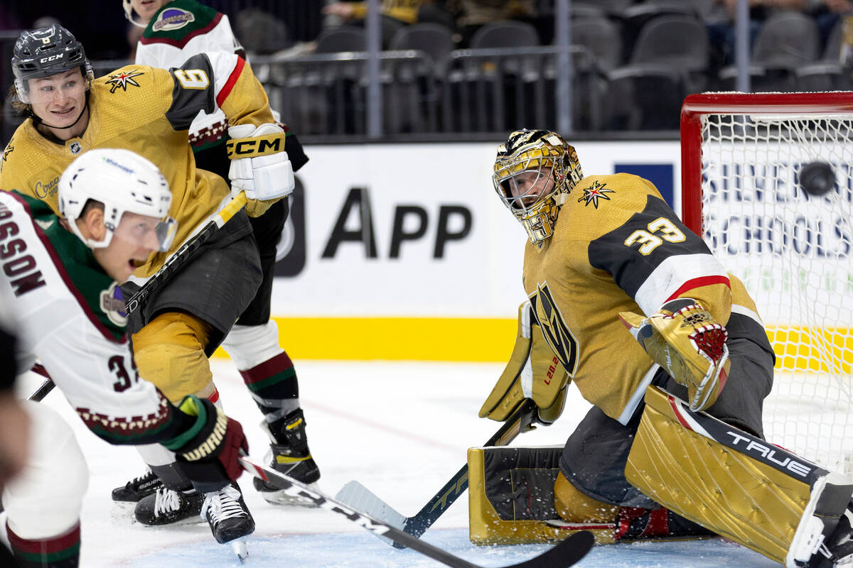 Golden Knights goaltender Adin Hill (33) moves to save a shot on goal by Coyotes forward Alex C ...