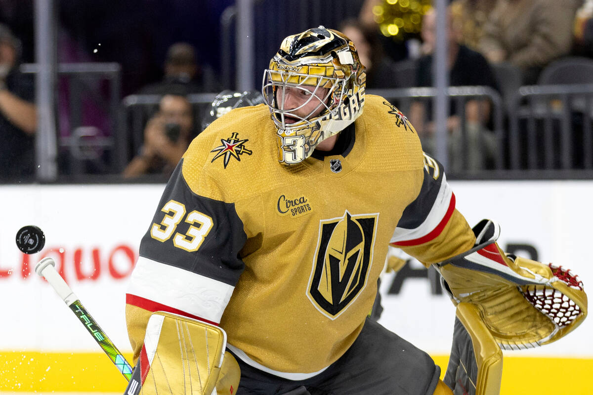Golden Knights goaltender Adin Hill (33) is about to miss a save during the second period of a ...
