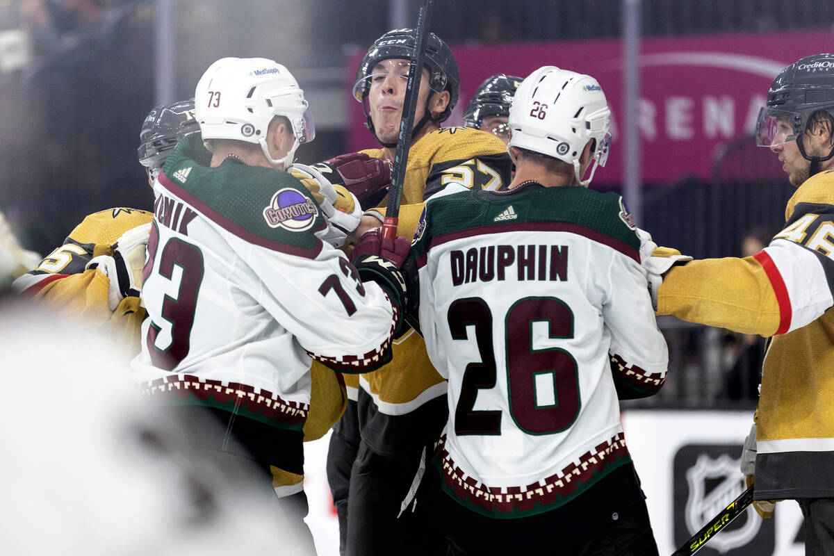 Golden Knights center Mason Primeau (57) fights with Coyotes forward Jan Jenik (73) and Coyotes ...