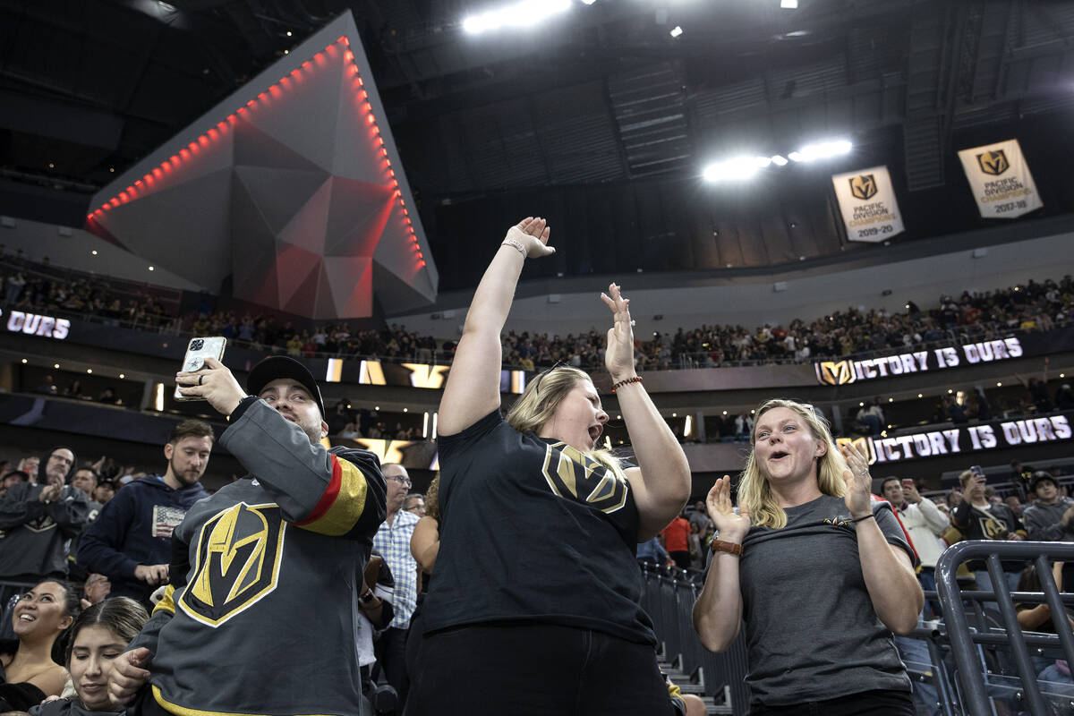 Golden Knights fans celebrate after their team won a preseason NHL hockey game against the Coyo ...