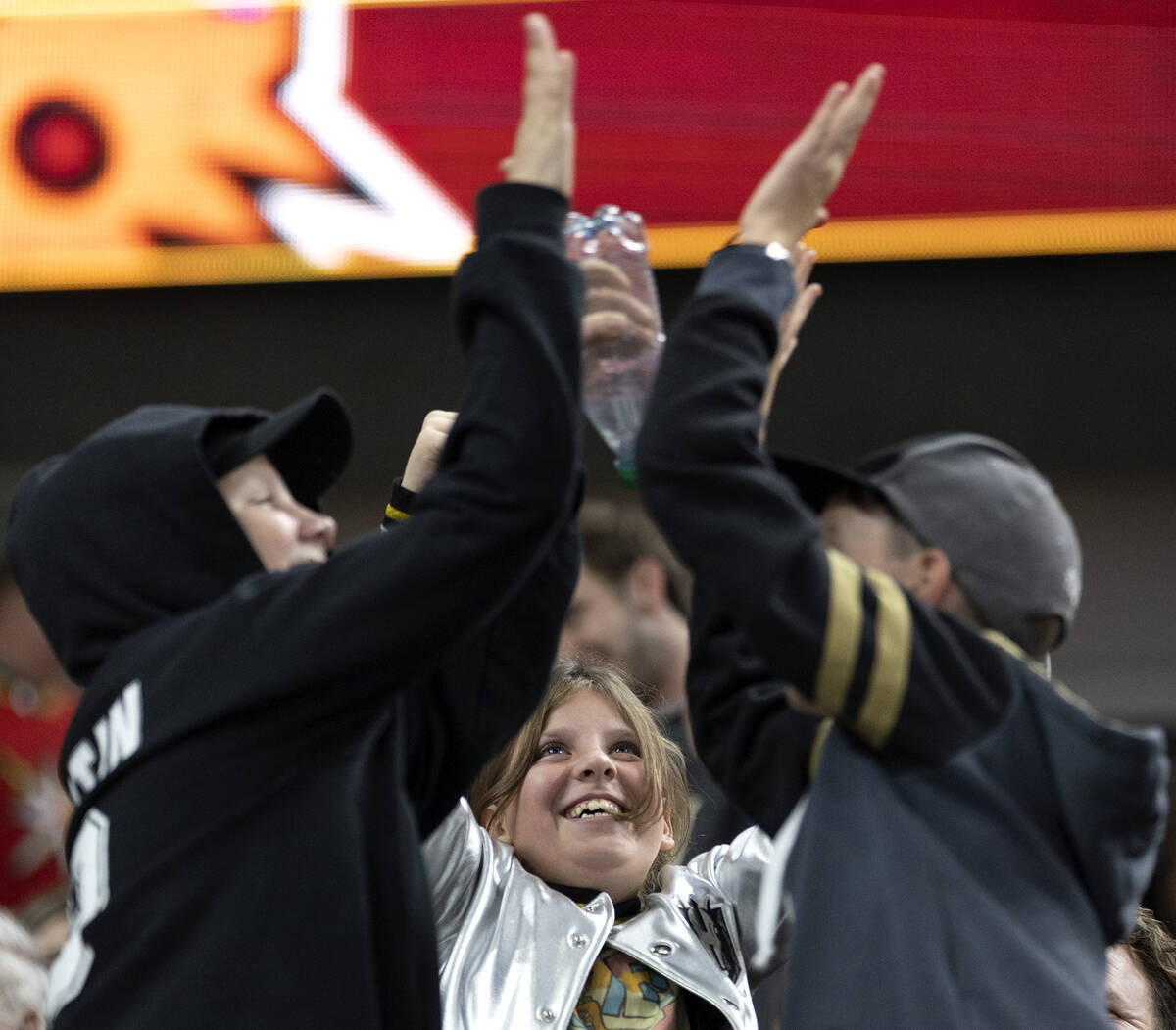 Golden Knights fans slap hands after left wing Pavel Dorofeyev (16) scored during the third per ...