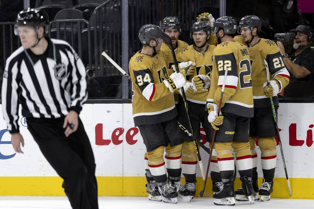 The Golden Knights surround center William Karlsson (71) after he scored during the third perio ...