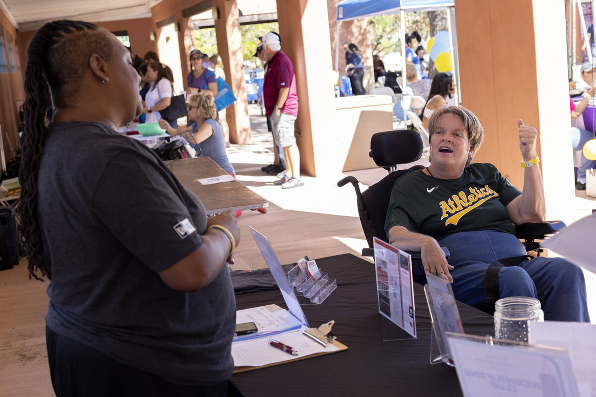 Elaine Triplett, right, speaks with vendors during a Disability Awareness Day event at Lorenzi ...