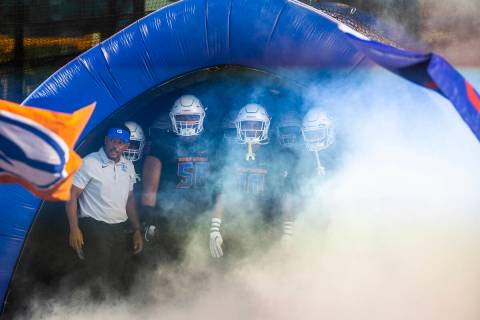 Bishop Gorman head coach Brent Browner, left, and players await introduction in the tunnel as t ...