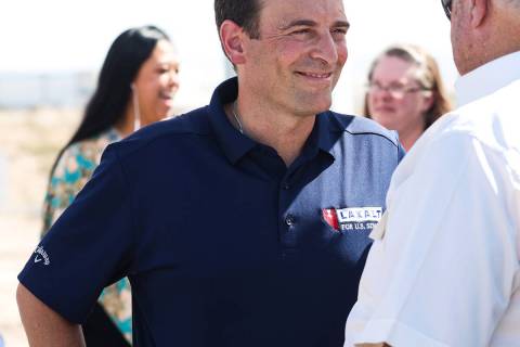 U.S. Senate candidate Adam Laxalt greets supporters prior to a panel discussing energy policy o ...