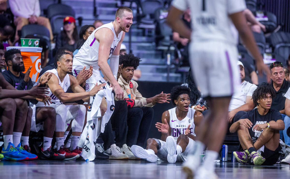 NBA G League Ignite guard Scoot Henderson (0, seated) cheers on the play joined by teammates on ...