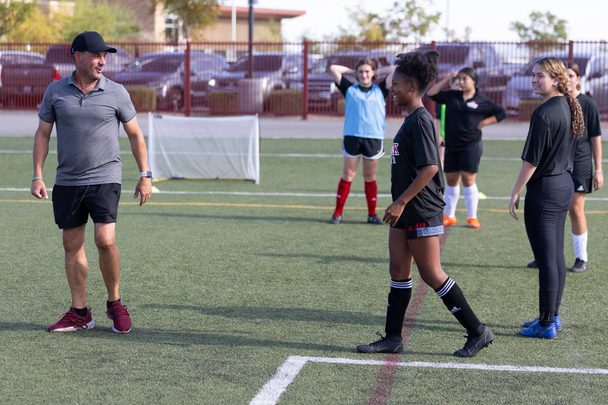 Soccer coach Kurt Divich talks to his players during a girls team practice at Doral Academy Red ...