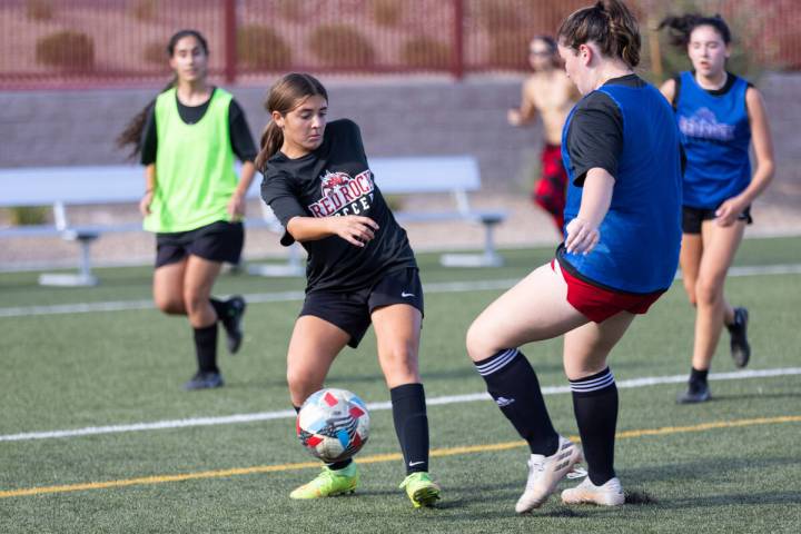 Sienna Turco, left, makes a pass during a girls soccer team practice at Doral Academy Red Rock ...