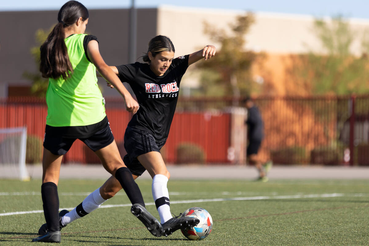 Peyton Gomez, center, dribbles the ball during a girls team soccer practice at Doral Academy Re ...
