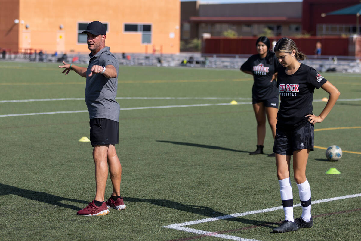 Soccer coach Kurt Divich talks to his players during a girls team practice at Doral Academy Red ...