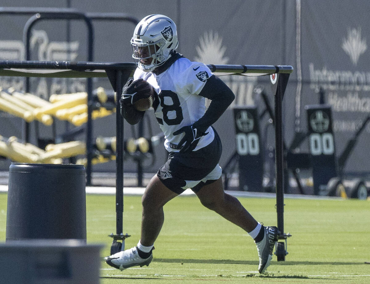 Raiders running back Josh Jacobs (28) runs a drill during practice at the Intermountain Healthc ...