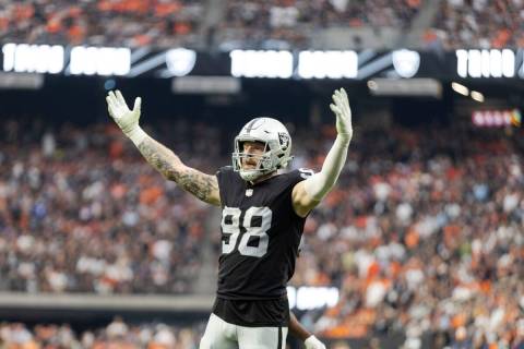Raiders defensive end Maxx Crosby (98) tries to rally the crowd on a third down play against th ...