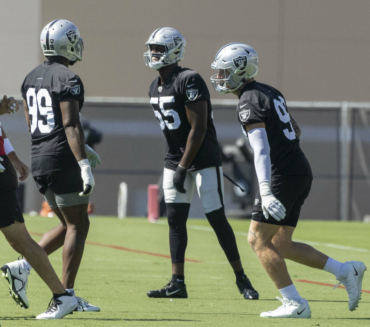 Raiders defensive ends Clelin Ferrell (99), Chandler Jones (55) and Maxx Crosby (98) interact d ...