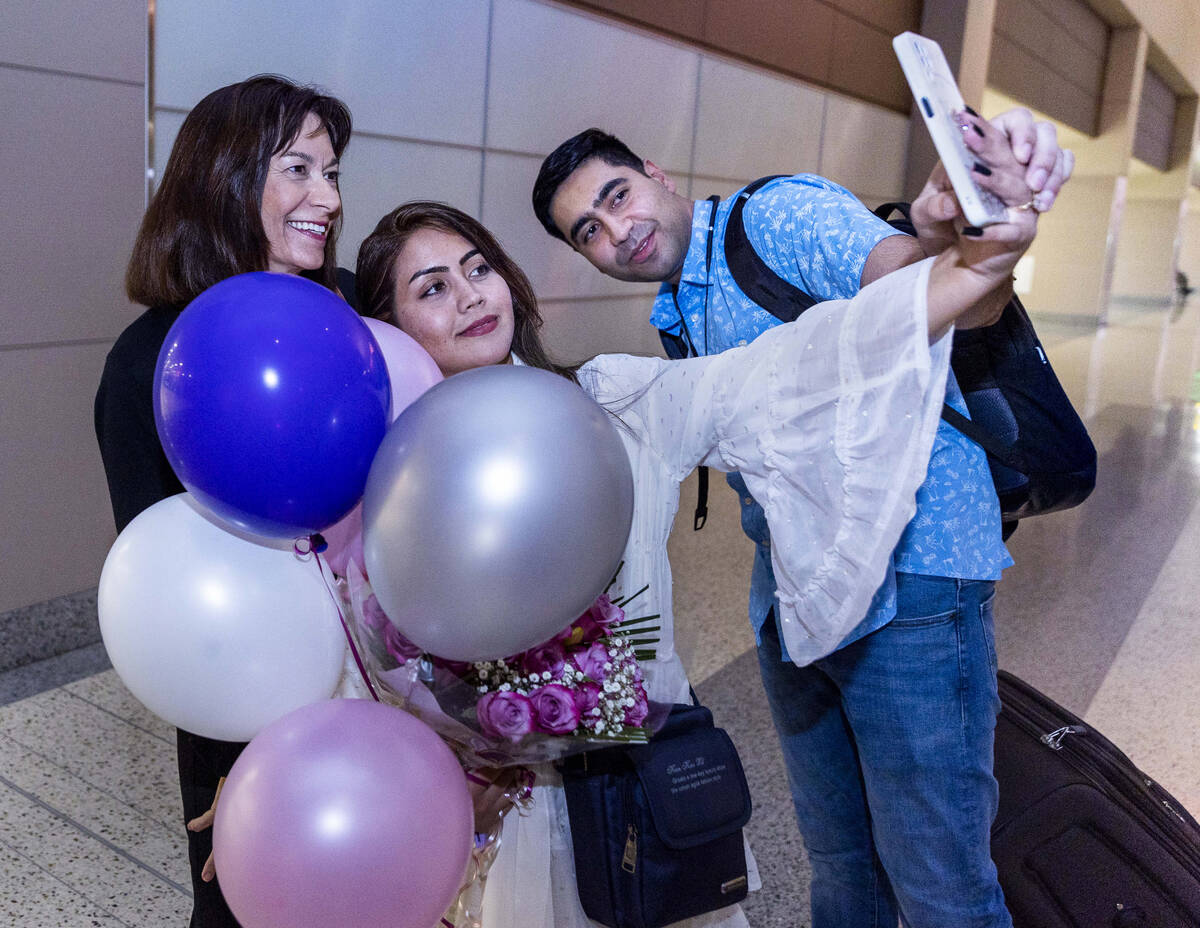 (From left) Ellen Hoffman takes a group selfie with Shabana and Mohammad "Benny" Shirzad in the ...