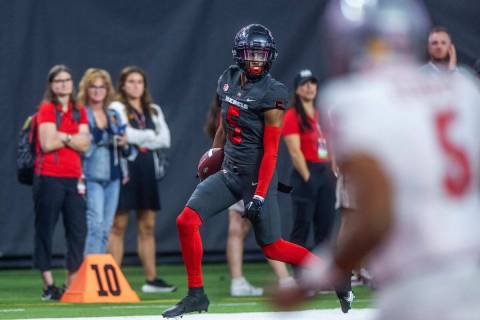 UNLV Rebels defensive back Cameron Oliver (5) heads to the end zone for a late score after an i ...