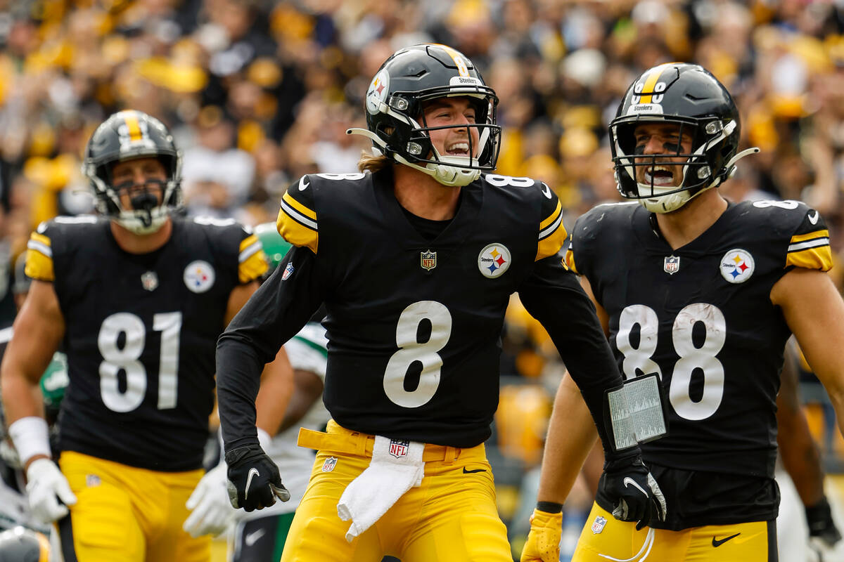 FILE - Pittsburgh Steelers quarterback Kenny Pickett celebrates after scoring a touchdown again ...