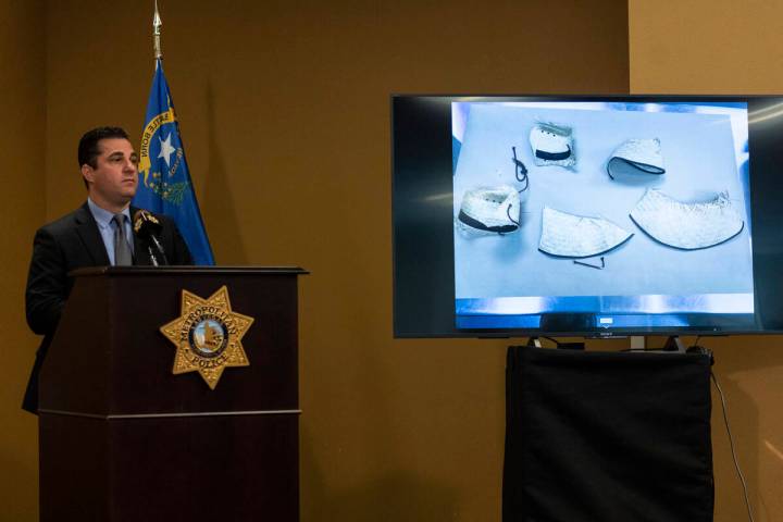 Case evidence is displayed on a screen as Las Vegas police captain Dori speaks on the arrest of ...