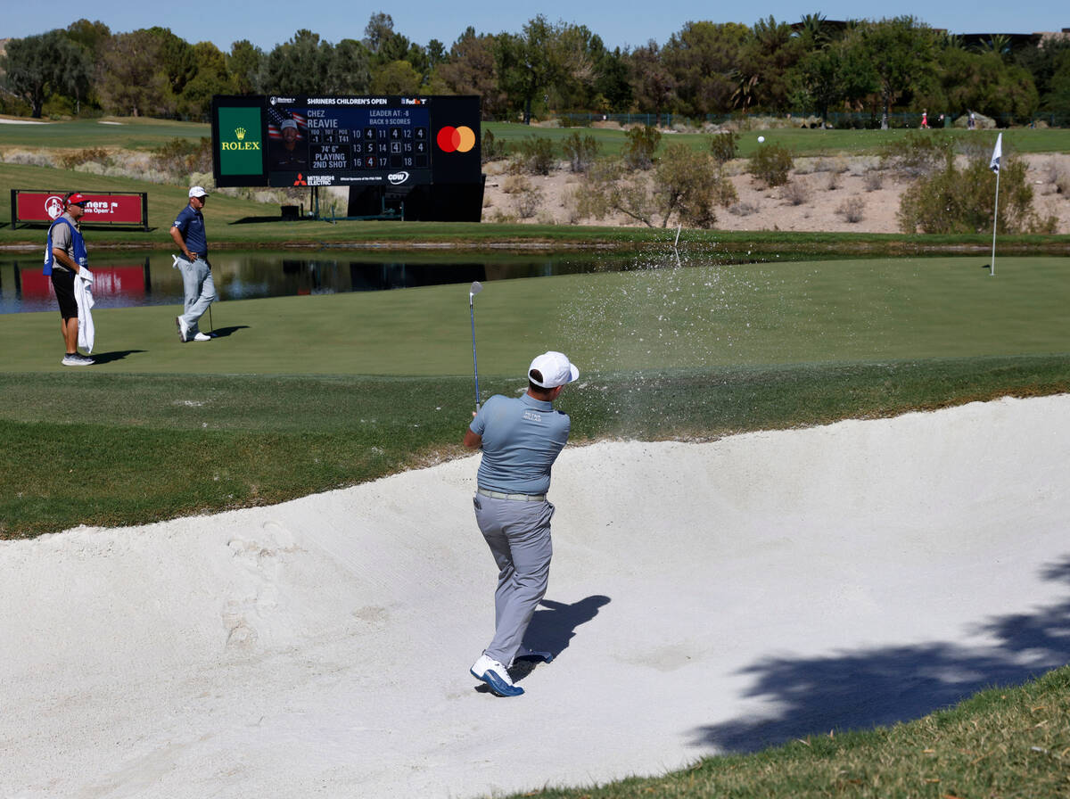 Chez Reavie hits out of the sand on the seventeenth hole during the first round of the Shriners ...