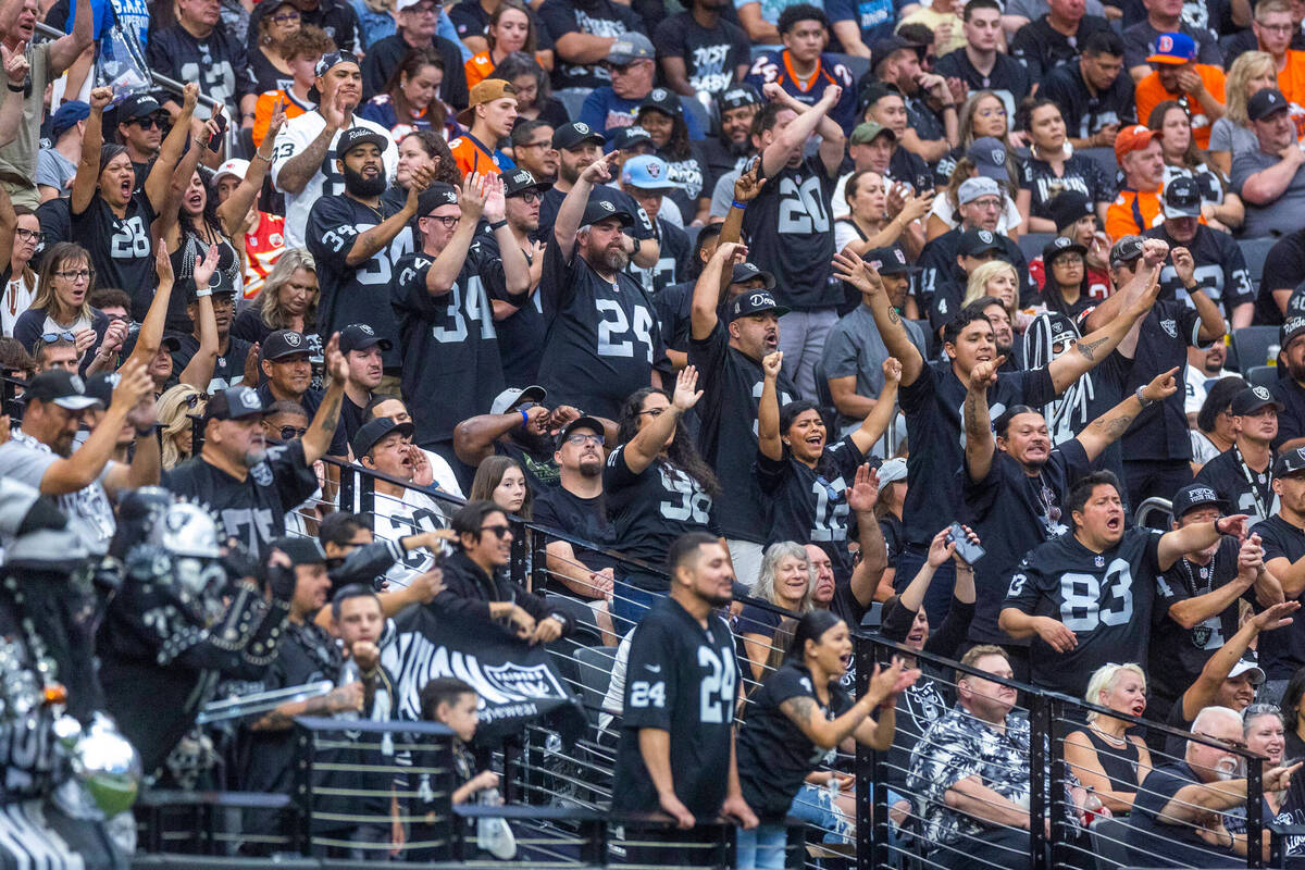 Raiders fans celebrate a score over the Denver Broncos during the first half of their NFL game ...