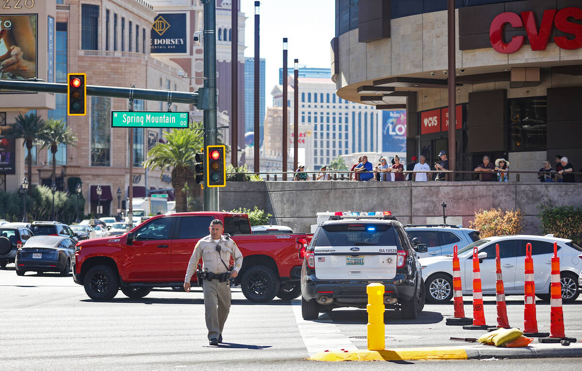 Police at the scene where multiple people were stabbed in front of a Strip casino in Las Vegas, ...