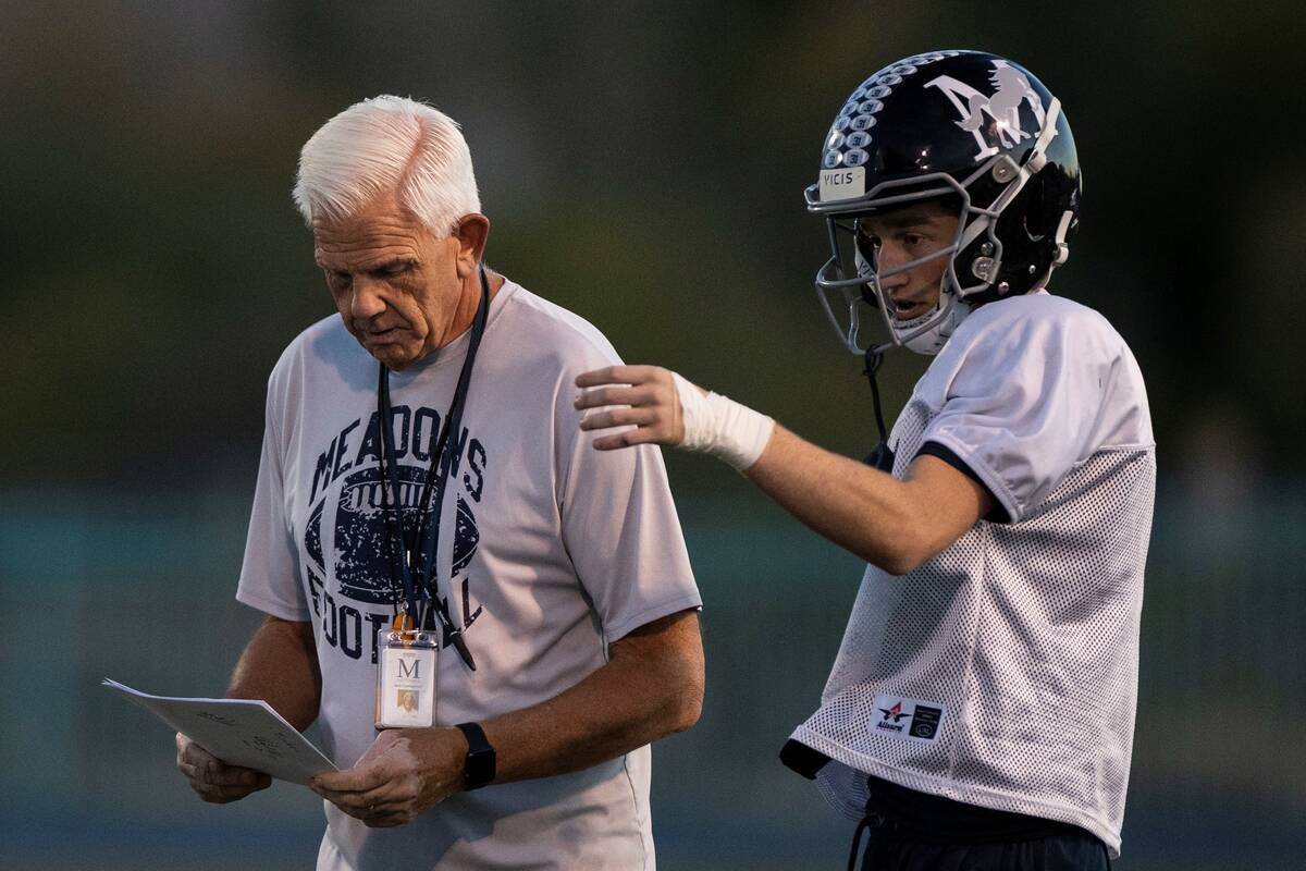 The Meadows High School football head coach Jack Concannon, left, discusses the game plan with ...