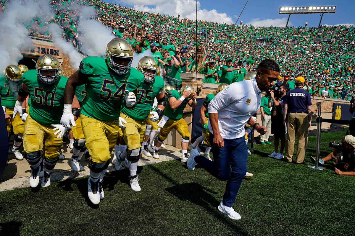 Notre Dame head coach Marcus Freeman leads his team through the tunnel and to the field before ...