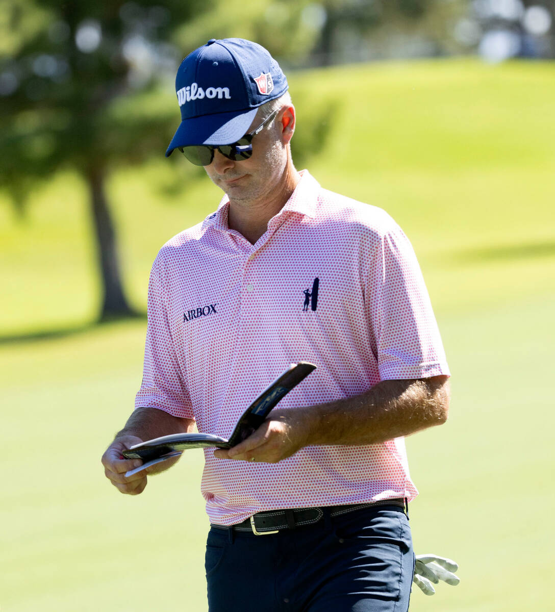 Kevin Streelman logs his strokes as he walks to the ninth green during the second round of the ...