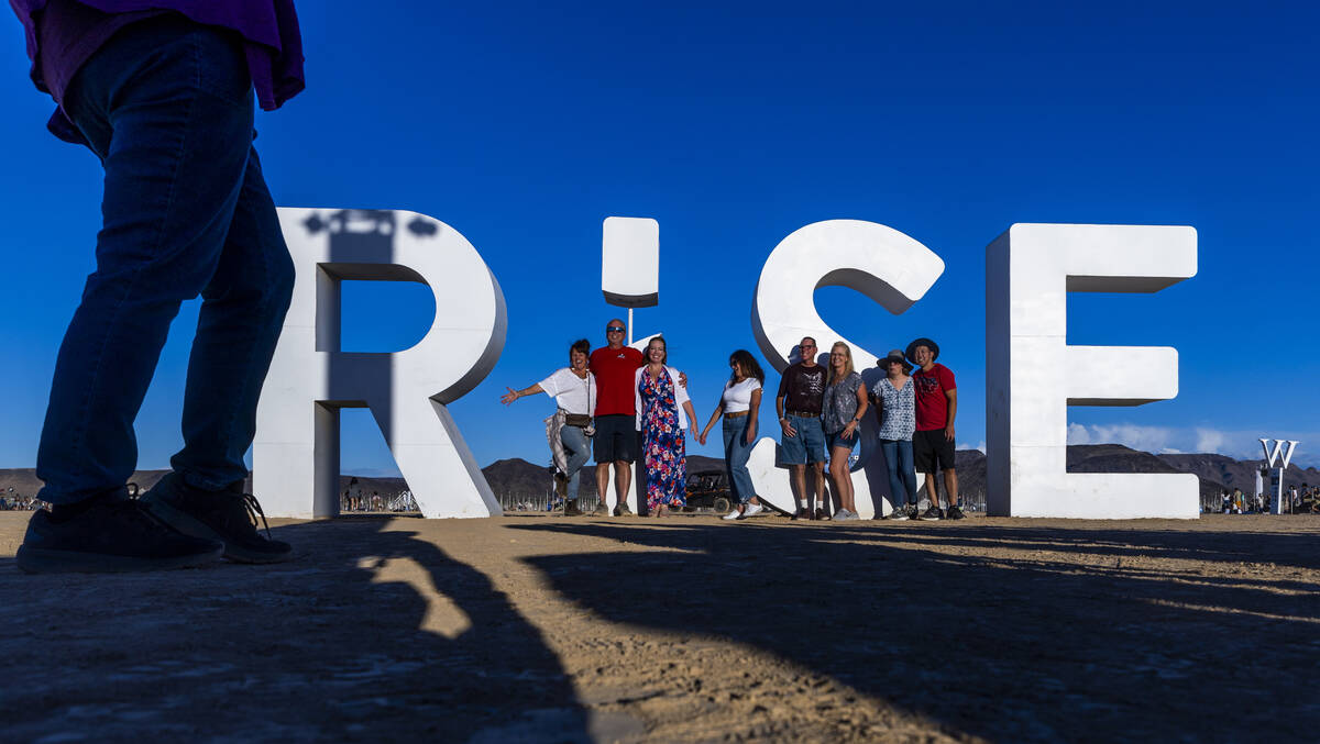 Friends gather at the giant letters inside the entrance during the RiSE Lantern Fest at the Jea ...
