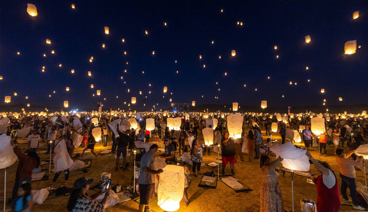 People release lanterns as a group during the RiSE Lantern Fest at the Jean Dry Lake Bed on Fri ...