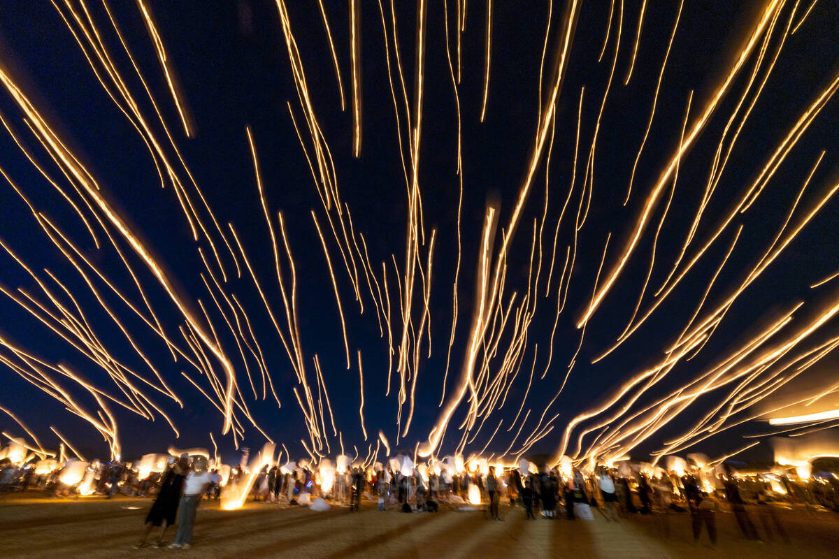 People release lanterns as a group during the RiSE Lantern Fest at the Jean Dry Lake Bed on Fri ...