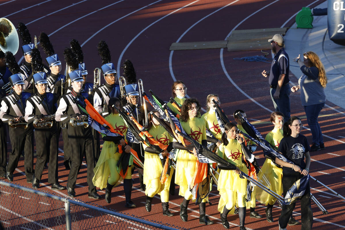 Shadow Ridge High School marching band members perform before a football game against Coronado, ...