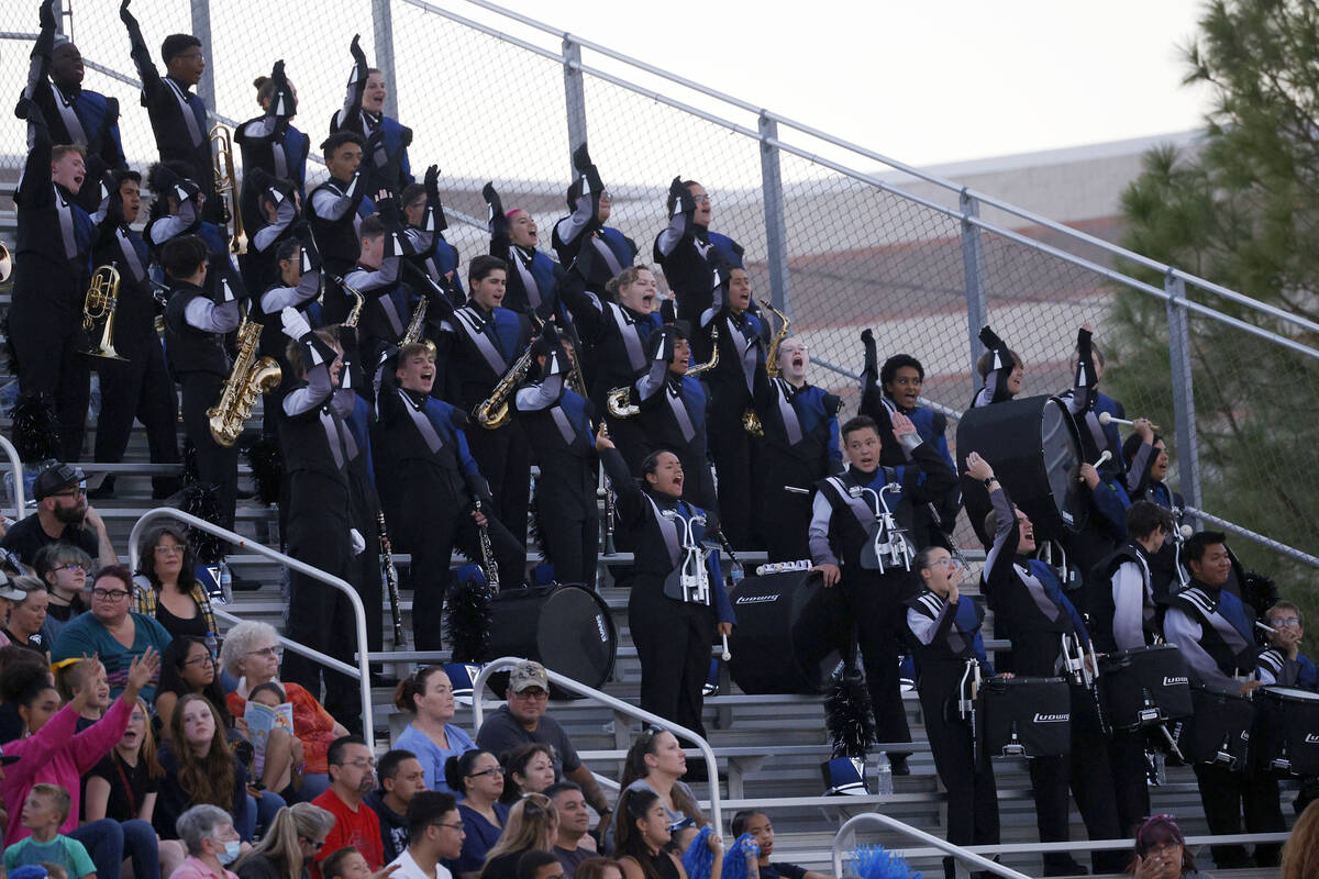 Shadow Ridge High School marching band members perform during the first half of a football game ...
