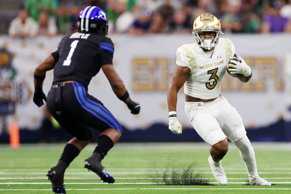 Notre Dame Fighting Irish running back Logan Diggs (3) runs the ball against Brigham Young Coug ...
