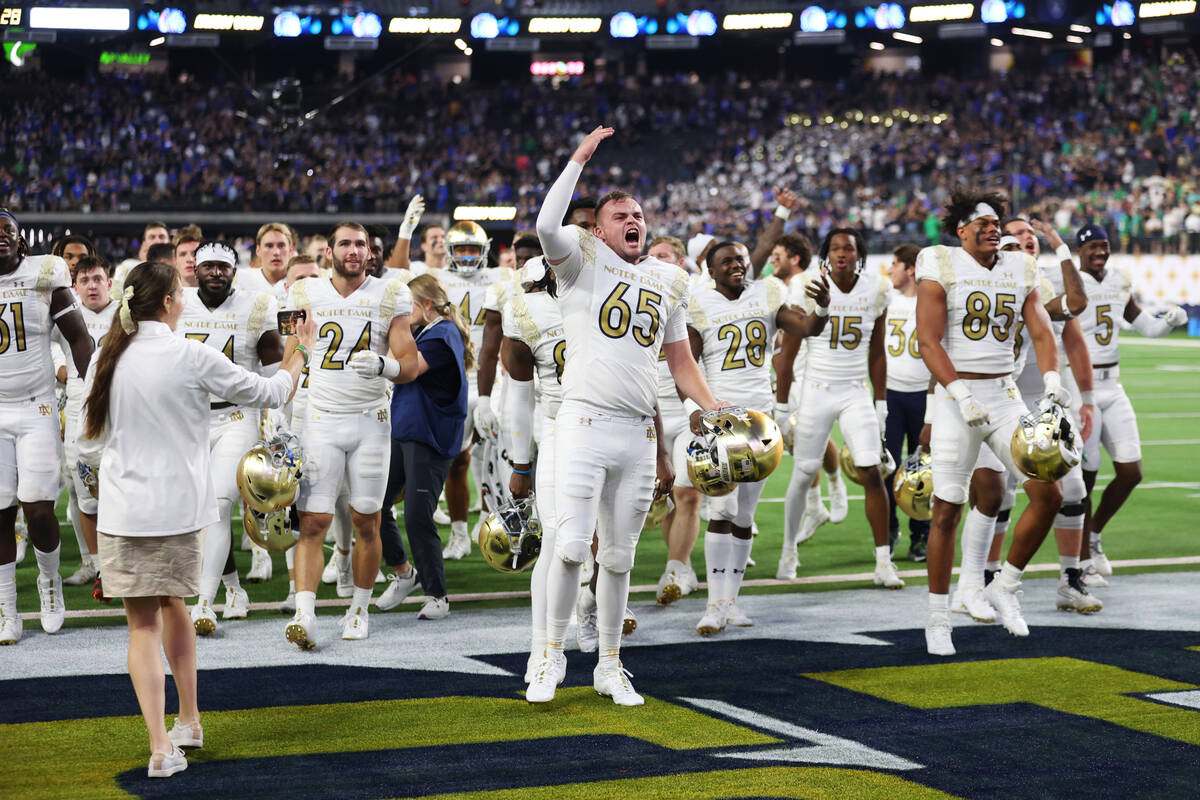 The Notre Dame Fighting Irish celebrate their win against Brigham Young Cougars during a NCAA f ...
