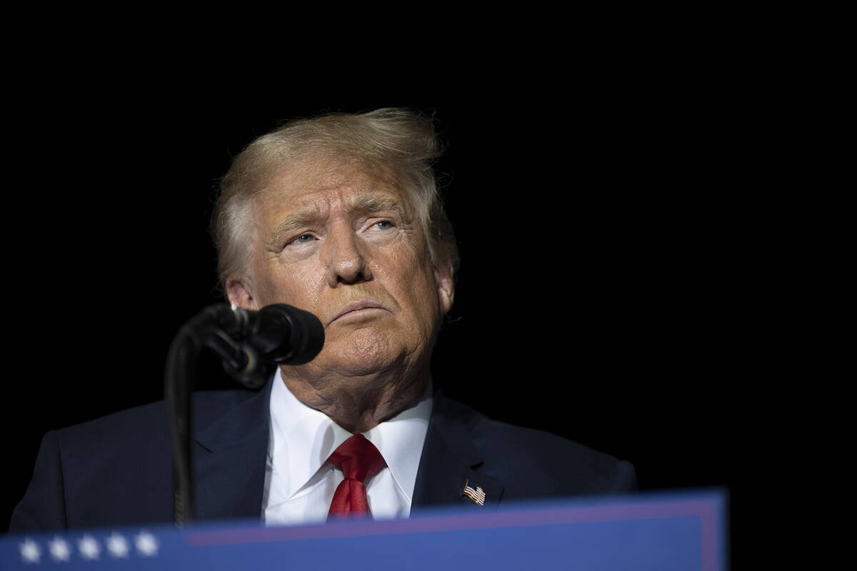 Former President Donald Trump pauses while speaking at a rally at the Minden Tahoe Airport in M ...