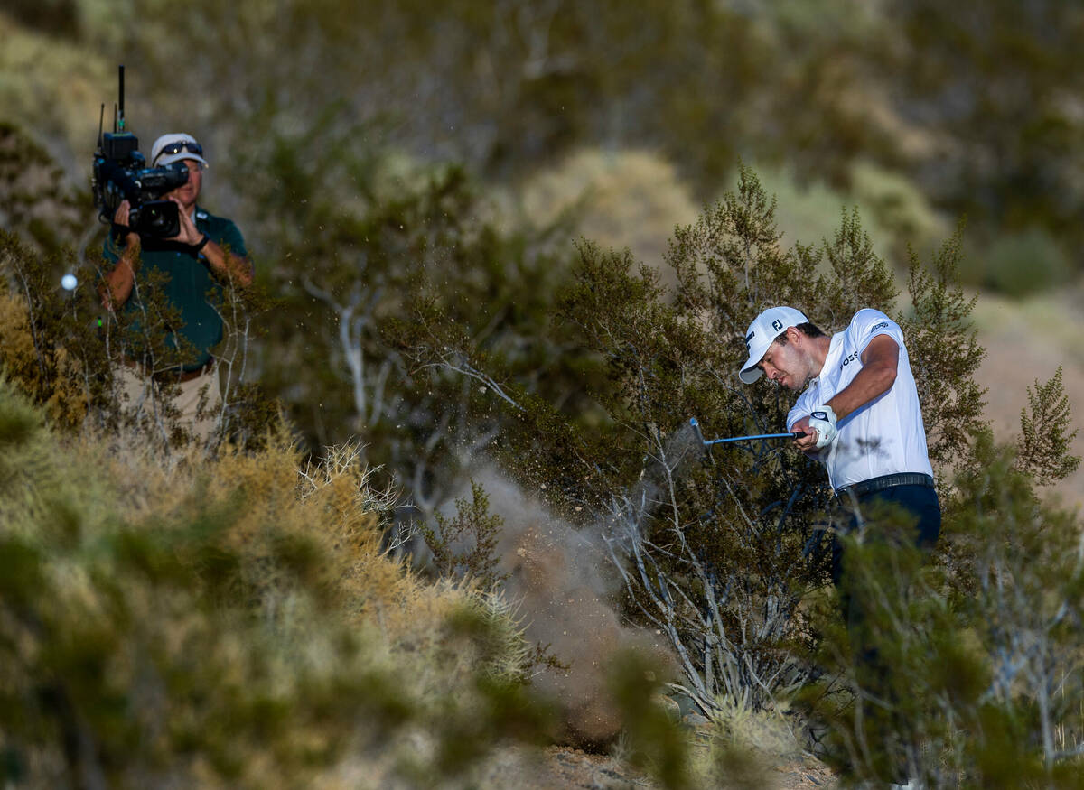 Patrick Cantlay wedges the ball from the desert rough on the 18th hole where he fell behind Tom ...