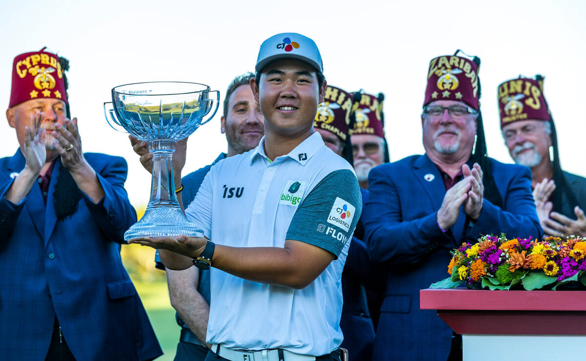 Tom Kim holds up his winning trophy during the final day of play in the Shriners Children's Ope ...