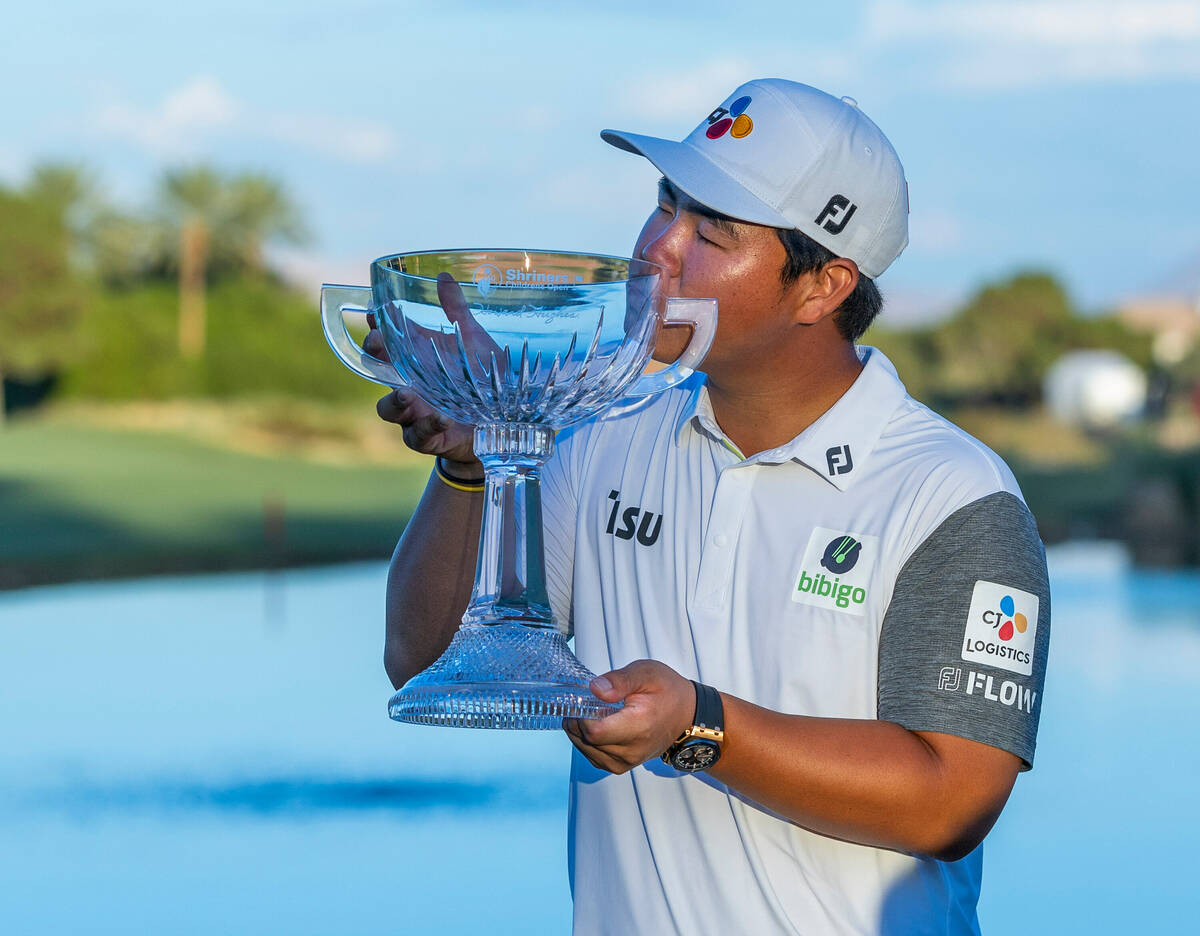 Tom Kim kisses his winning trophy during the final day of play in the Shriners Children's Open ...