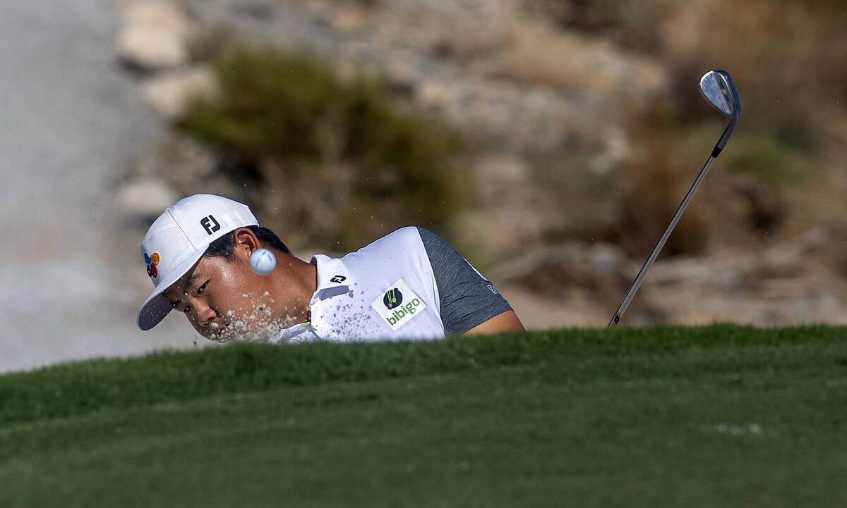 Tom Kim wedges the ball out of a sand trap on the fifth hole during the final day of play in th ...