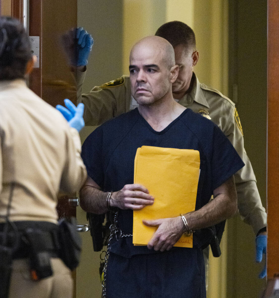 Robert Telles is led into the courtroom during a court hearing in the civil case at the Regiona ...