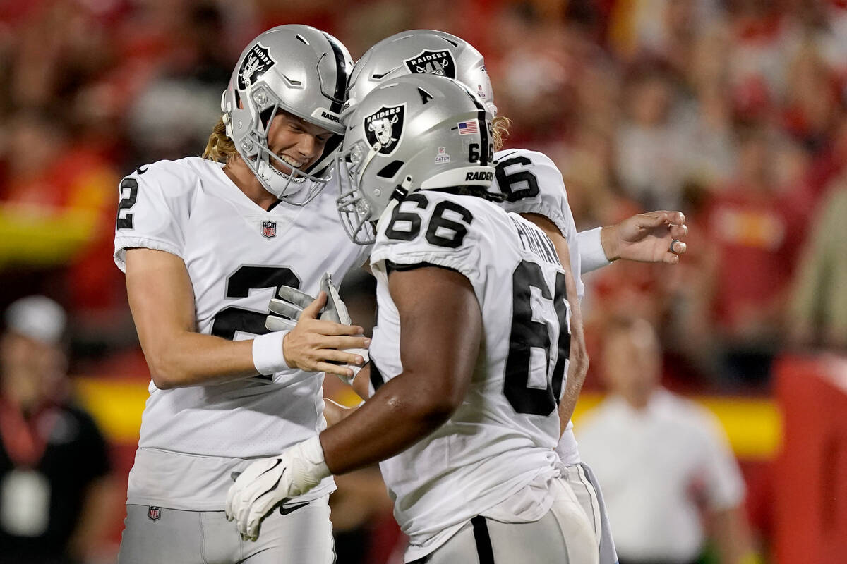 Las Vegas Raiders place kicker Daniel Carlson (2) is congratulated by Dylan Parham (66) after k ...