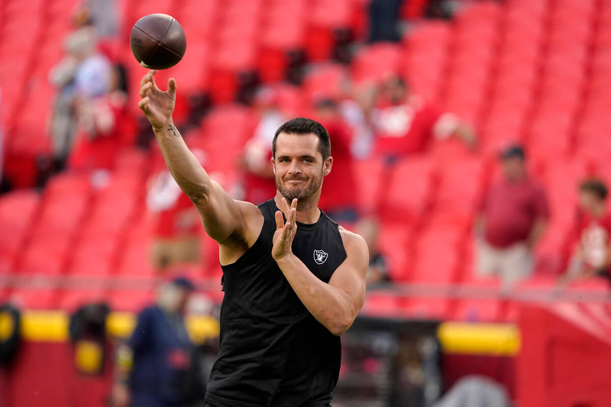 Las Vegas Raiders quarterback Derek Carr warms up before the start of an NFL football game agai ...