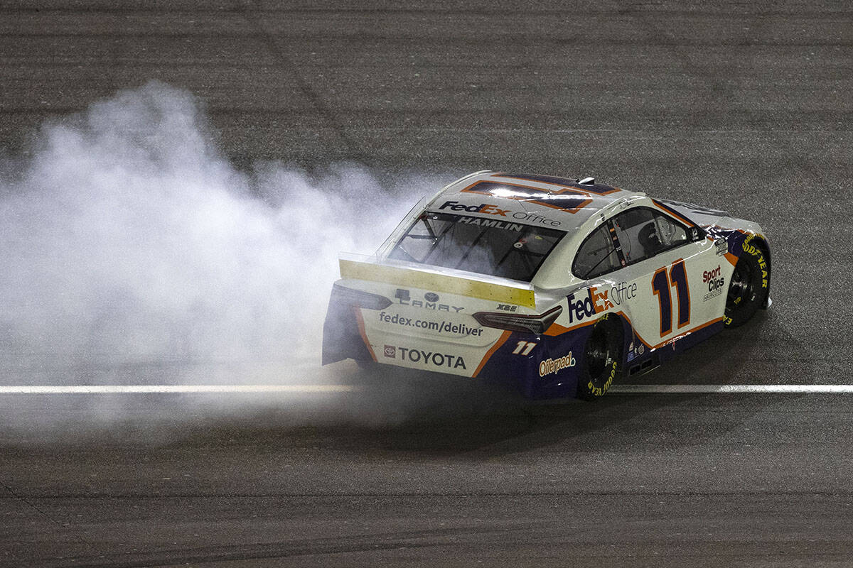 Denny Hamlin celebrates by spinning his number 11 after he won the 4th Annual South Point 400 a ...