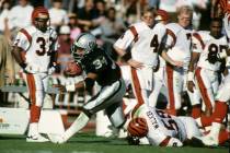 Los Angeles Raiders running back Bo Jackson carries the football for the last time as he suffer ...